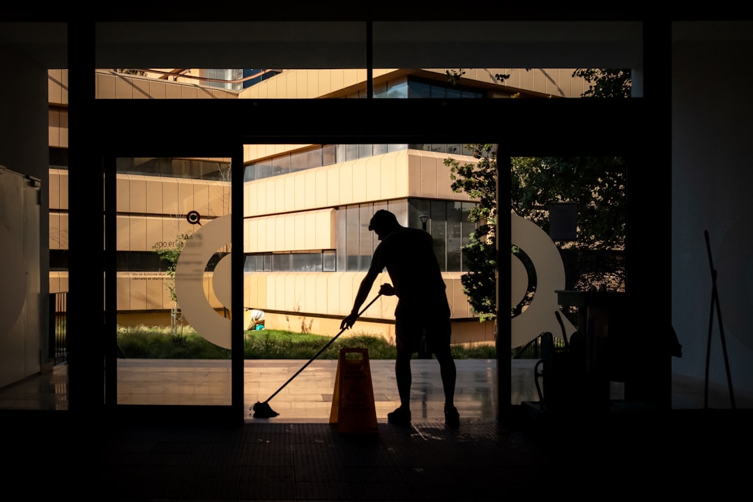 hero-img-01 Man cleans floor at an entrance door.