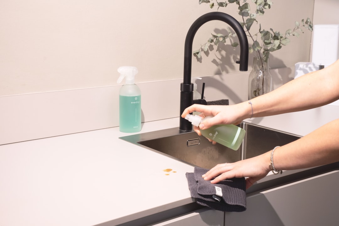 about-01 a-woman-is-cleaning-a-kitchen-sink-with-a-rag-sqomdoqb3ws